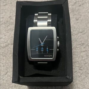 Nixon Silver Stainless Steel Square Watch with Black Dial and Blue Accents